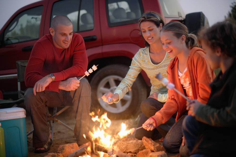 Family roasting marshmallows together.