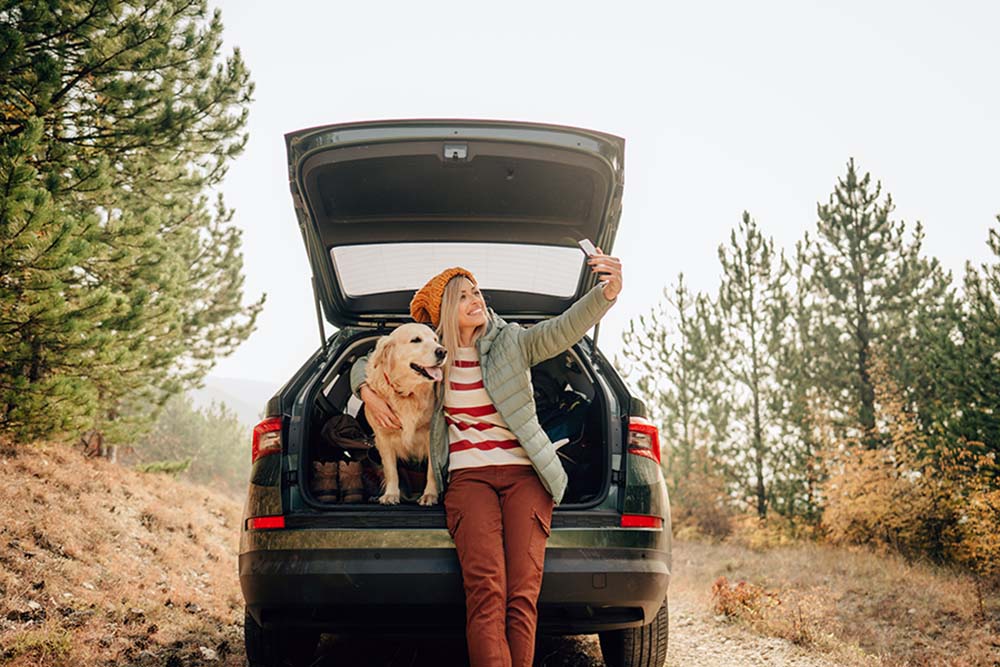 A woman taking a selfie with a dog.