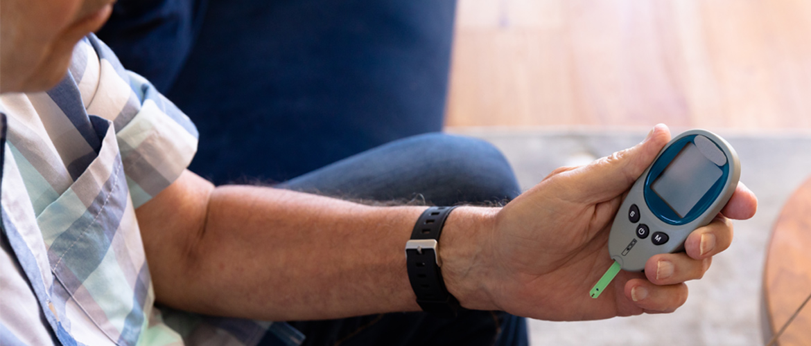 Man checks his blood glucose monitor