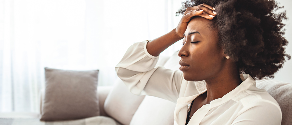 woman holding head because of stress